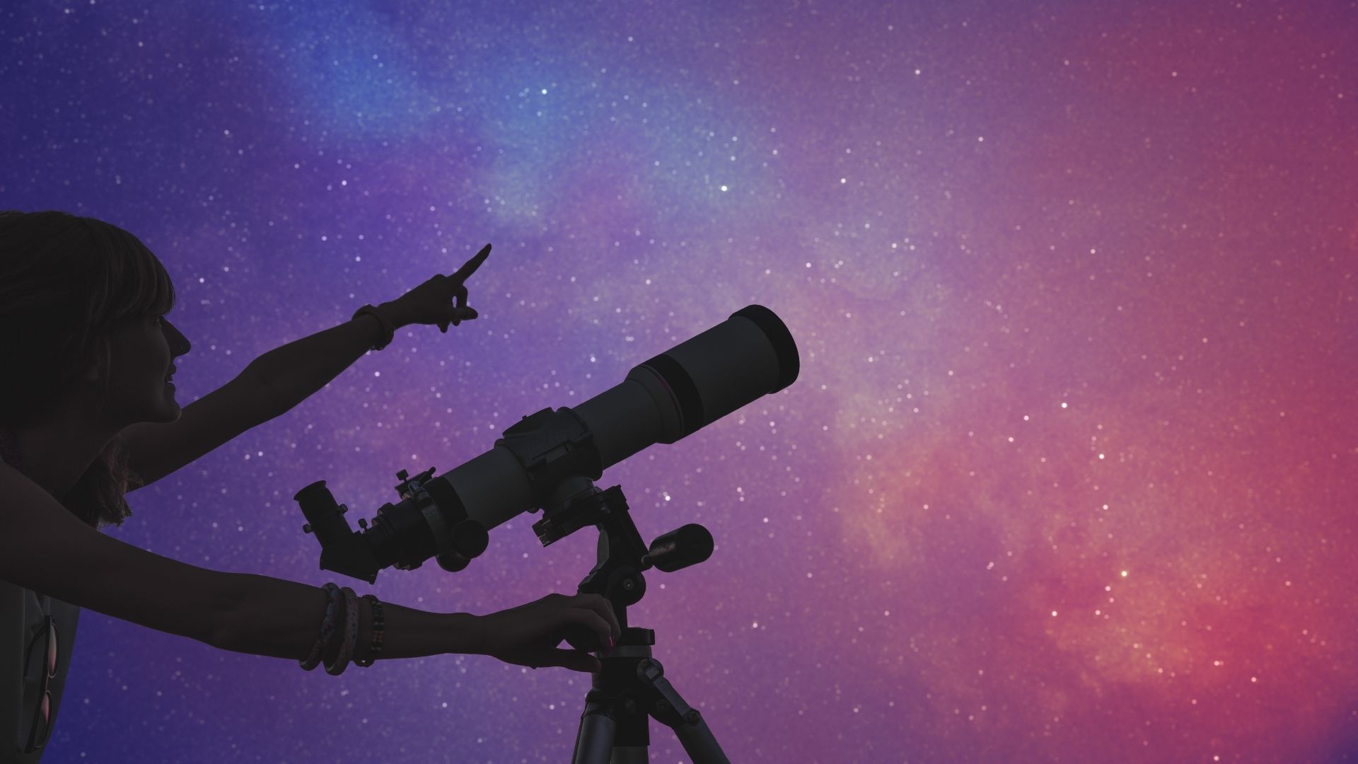 A person gazing at the night sky with a telescope