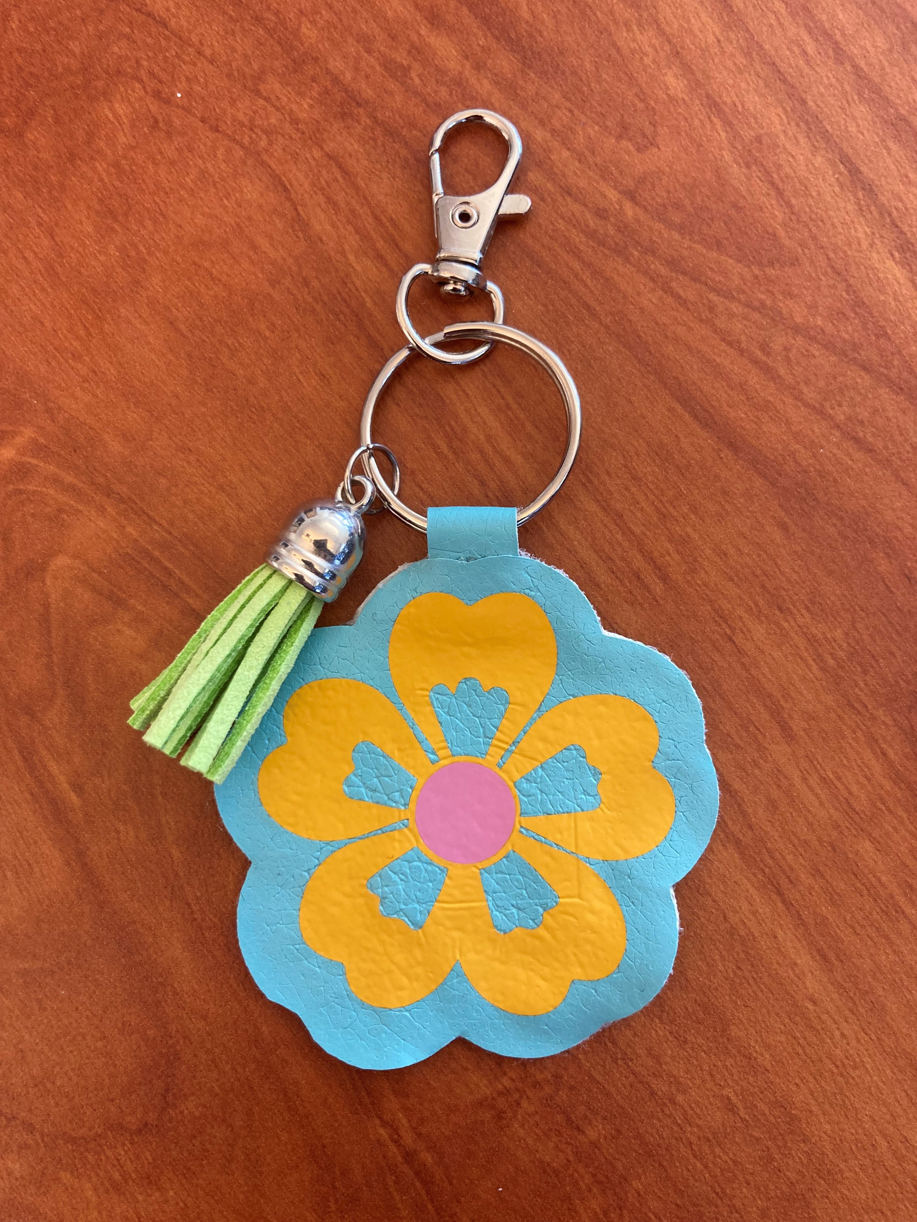 Blue faux leather flower shaped keychain.