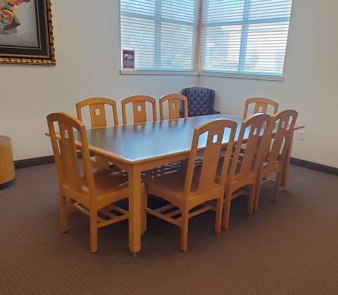 small conference room set up with table and 8 chairs
