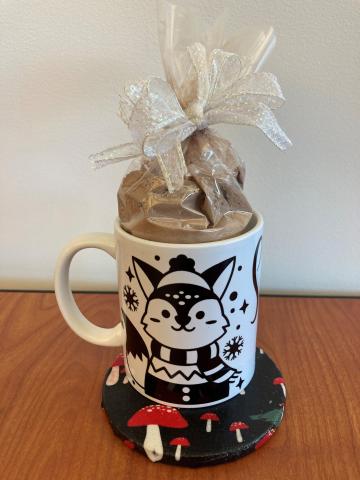 winter-themed mug and coaster; bag of hot chocolate