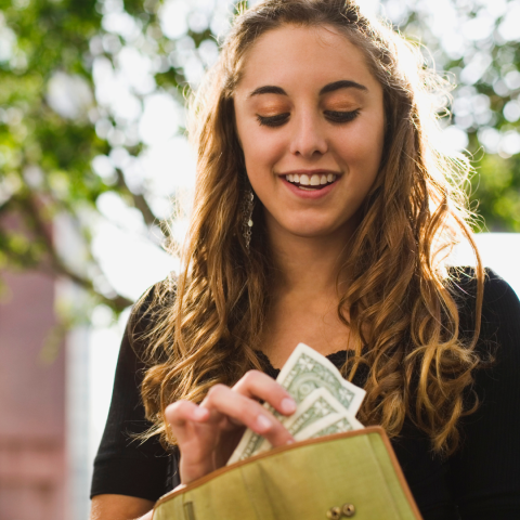 decorative image of teen holding cash
