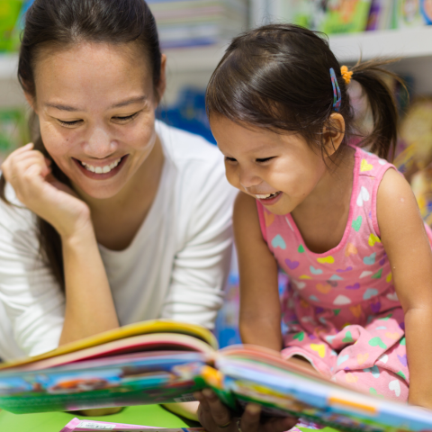 decorative image of parent reading to toddler