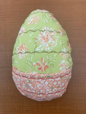 Fabric egg with a pocket on the front.