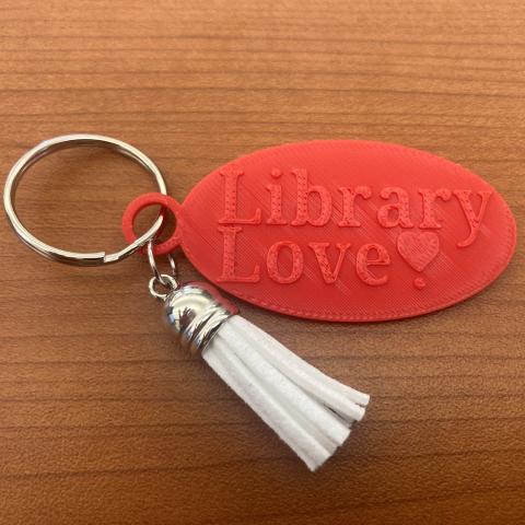 Keychain that reads "library love" and a tassel