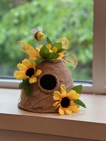 decorative image of beehive with needle felted bees