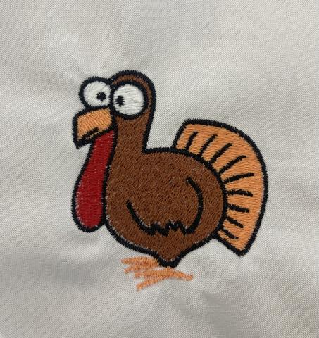 Cartoon turkey embroidered on a fabric napkin