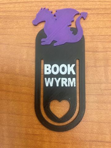 3D printed bookmark with a dragon on the top and the words "book wyrm"