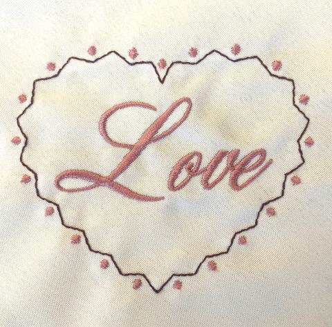 Embroidered heart with the word "love" in it
