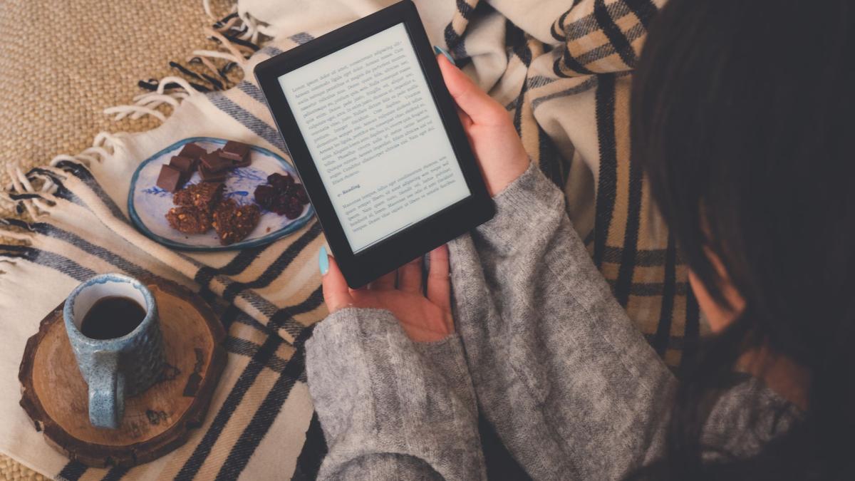 woman reading book on tablet