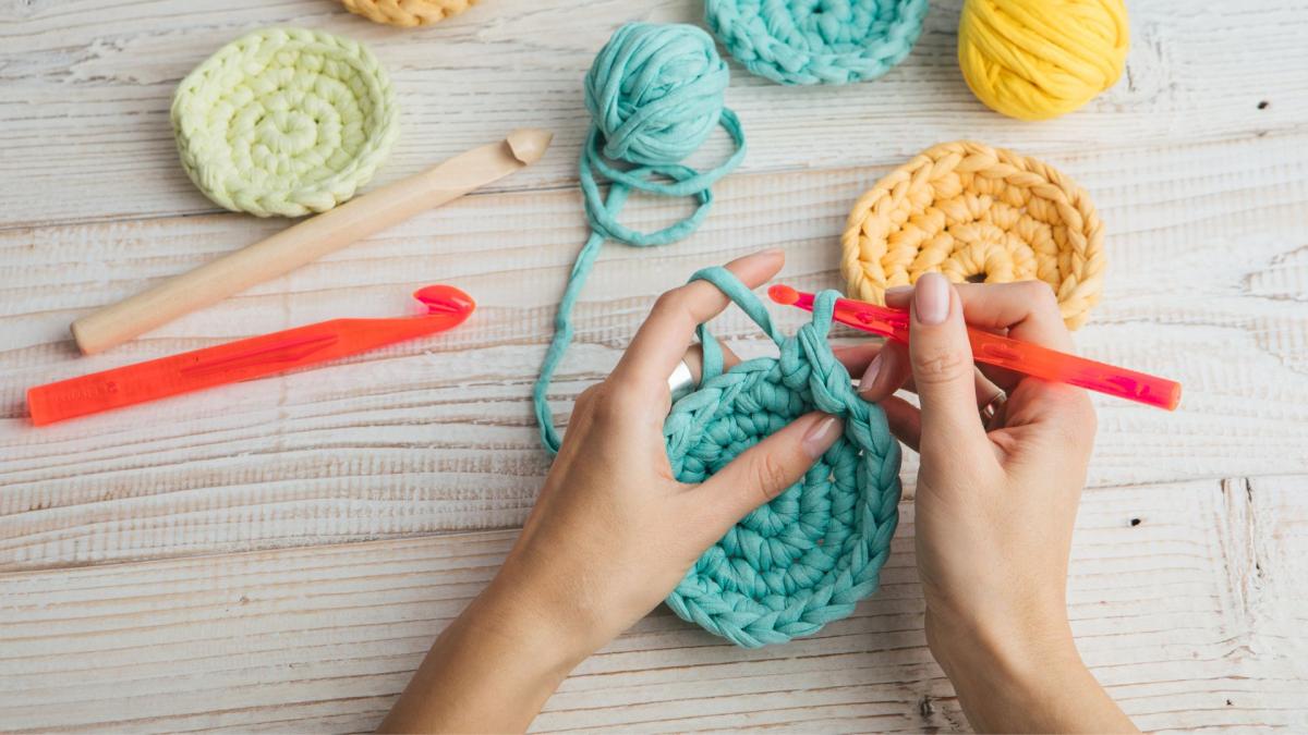 a person creating a project with crochet