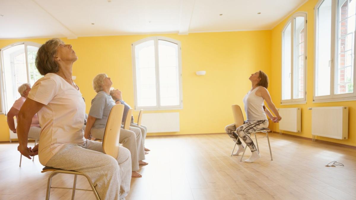 Adults participating in a sit and fit exercise class