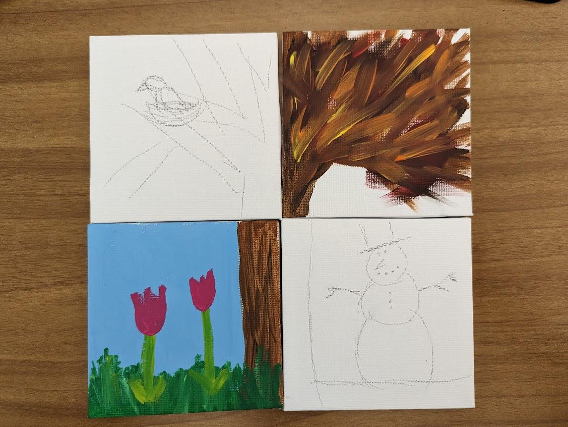 four mini canvases with a large tree drawn over all of them. each corner depicts the tree in a different season and two corners are painted