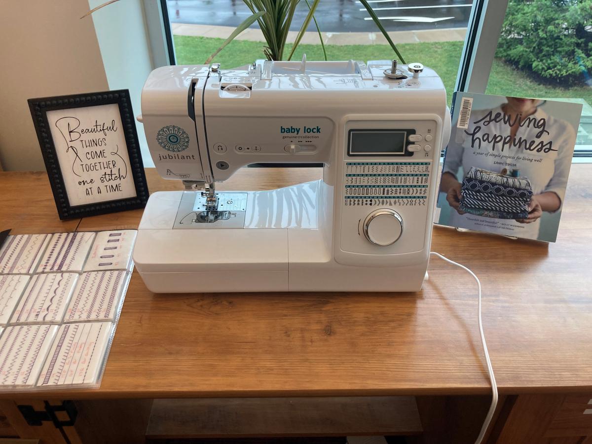 Sewing machine with a book about sewing