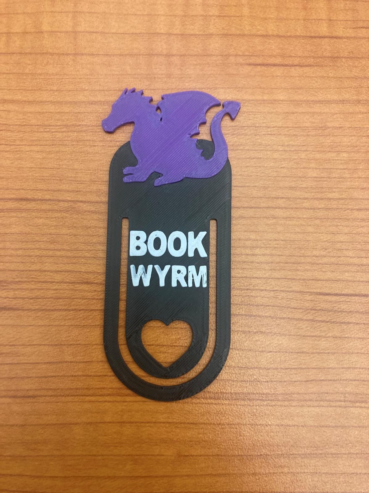 3D Printed bookmark with a dragon at the top and text that reads "Book wyrm"