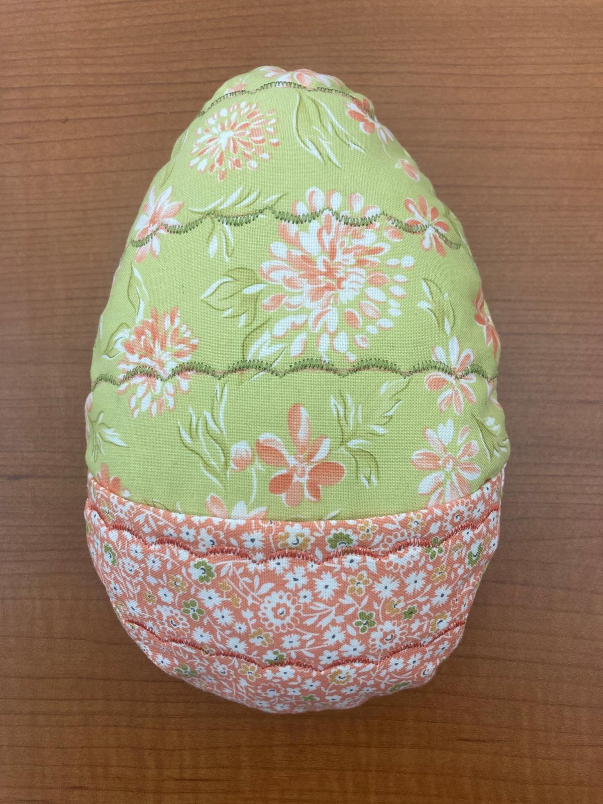 Fabric egg with a pocket on the front.
